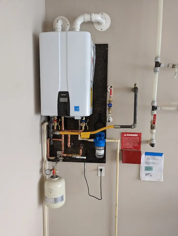 Professional plumber installing copper piping in a Bucyrus home